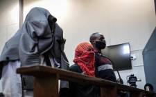 FILE: (From left to right) Simon Scorpion Nyalvane, Caylene Whiteboy and Voster Netshiongolo, the police officers accused of murdering Nathaniel Julies (16), appear in the Proteas Magistrates Court on 22 September 2020. Picture: Abigail Javier/EWN