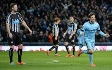 Manchester Citys Spanish midfielder David Silva (R) celebrates after scoring his teams fifth goal during the English Premier League football match between Manchester City and Newcastle at the The Etihad Stadium in Manchester, north west England on 21 February, 2015. Picture: AFP