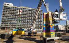 Workers and volunteers help assemble bricks during the construction of a Lego tower in Tel Aviv's Rabin Square on 26 December, 2017, as the city attempts to break Guinness world record of the highest such structure. Picture: AFP
