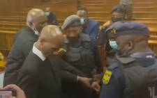 A screengrab of Advocate Malesela Teffo (foreground, left) being arrested in the Pretoria High Court on 28 April 2022.