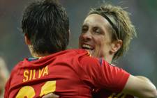 Spanish midfielder David Silva (L) is congratulated by Spanish forward Fernando Torres (R) after scoring a goal during the Euro 2012 championships football match Spain vs Republic of Ireland on June 14, 2012. Picture: AFP.