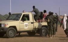 FILE: Soldiers gather at a pickup truck following a suicide bomb attack in Mali. Picture: AFP.