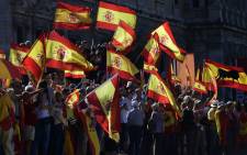 Protestors gather holding Spanish flags during a demonstration against independence of Catalonia called by DENAES foundation for the Spanish Nation Defence at Colon square in Madrid on October 07, 2017. Picture: AFP