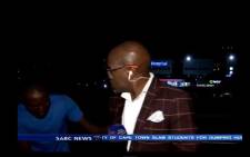 Screengrab of a YouTube video showing SABC’s contributing editor, Vuyo Mvoko, being mugged during a live crossing on 10 March 2015.