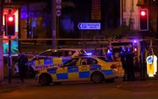 Police deploy at the scene of an explosion in Manchester, England, on 23 May 2017 at an Ariana Grande concert. Picture: AFP.