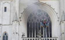 Firefighters are at work to put out a fire at the Saint-Pierre-et-Saint-Paul cathedral in Nantes, western France, on July 18, 2020. Picture: AFP