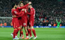 Liverpool's midfielder Jordan Henderson celebrates with teammates after scoring a goal during the UEFA Champions League semifinal first leg football match between Liverpool and Villarreal, at the Anfield Stadium, in Liverpool, on 27 April 2022. Picture: LLUIS GENE/AFP