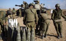 FILE: Israeli soldiers organise 155mm shells near the Israeli border with the Gaza Strip, on 17 July, 2014. Picture: AFP.