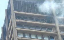Five firefighters seen on the balcony of a burning building in Joburg. Picture: Christa Eybers/EWN