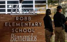 Law enforcement officers speak together outside of Robb Elementary School following the mass shooting at Robb Elementary School on May 24, 2022 in Uvalde, Texas.  Picture: AFP.