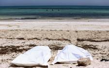This file photo picture taken on 6 July 2019 on the beach of Aghir in Tunisia's southern island of Djerba shows recovered bodies from a boat carrying 86 migrants that capsized off the Tunisian coast while crossing the Mediterranean from Libya to Italy. Picture: AFP