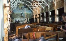 FILE: Journalists take pictures inside St. Anthony's Shrine in Colombo on April 26, 2019, following a series of bomb blasts targeting churches and luxury hotels on Easter Sunday in Sri Lanka. Picture: AFP