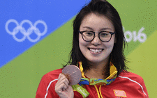 China's Fu Yuanhui poses with her bronze medal on the podium of the Women's 100m Backstroke during the swimming event at the Rio 2016 Olympic Games at the Olympic Aquatics Stadium in Rio de Janeiro on August 8, 2016. Picture: AFP 