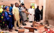 FILE: Ondo State governor Rotimi Akeredolu (3rd L) points to blood the stained floor after an attack by gunmen at St. Francis Catholic Church in Owo town, southwest Nigeria on June 5, 2022. Picture: AFP