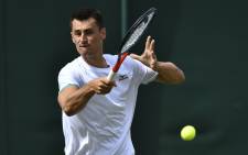 Australia's Bernard Tomic returns against France's Jo-Wilfried Tsonga during their men's singles first round match on the second day of the 2019 Wimbledon Championships at The All England Lawn Tennis Club in Wimbledon, southwest London, on 2 July 2019. Picture: AFP