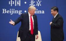 FILE: US President Donald Trump (L) gestures next to China's President Xi Jinping during a business leaders event at the Great Hall of the People in Beijing on 9 November 2017. Picture: AFP