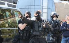 FILE: A member of the RAID French police unit gestures near the Tocqueville high school in the southern French town of Grasse, on March 16, 2017 following a shooting that left eight people injured. Picture: AFP
