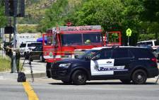 A police vehicle stands at a closed-off street outside the North Park Elementary School in San Bernadino, California on April 10, 2017 after a gunman entered a classroom and killed one woman and one student before turning the gun on himself. Picture: AFP