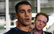 Footballer Hakeem al-Araibi (L) speaks to the media upon his arrival at the airport in Melbourne on 12 February 2019. Picture: AFP
