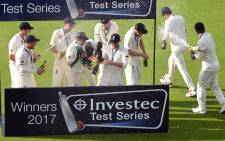 England players celebrate winning the fourth Test match, and Test series, against South Africa, on day 4 of the fourth Test match at Old Trafford cricket ground in Manchester on 7 August, 2017. Picture: AFP.