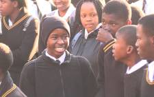 An Orlando West High School pupil shares a joke with a friend during assembly. Picture: Vumani Mkhize/EWN. 