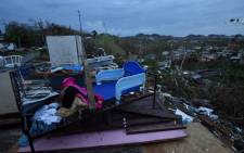 Debris is scattered around a destroyed house in the Acerolas neighbourhood, in Toa Alta, Puerto Rico, on 1 October 2017. Picture: AFP.