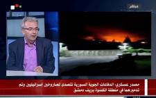 A TV grab from a broadcast by the official Syrian Arab News Agency (SANA) on 8 May 2018 shows a Syrian presenter speaking with images on the right purportedly showing the aftermath of two intercepted Israeli missiles. Picture: AFP.