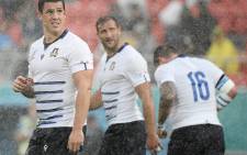 Italy's players stand in the rain during the Japan 2019 Rugby World Cup Pool B match between Italy and Namibia at the Hanazono Rugby Stadium in Higashiosaka on 22 September 2019. Picture: AFP