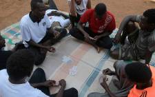 Sudanese asylum seeker play poker outside their temporary houses at Gashora Emergency Transit Centre in Gashora, Rwanda, on June 25, 2022. Picture: AFP.