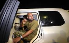 This file photo taken in 2011 shows Saif al-Islam Gaddafi appearing in front of supporters and journalists at his father’s residential complex in Tripoli. Picture: AFP.