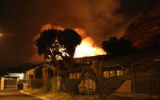 The fire blazes on near a residential area in the Cape Town surrounds. Picture Stephen Phillipson/EWN