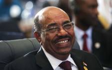 Sudanese President Omar al-Bashir smiles as he attends the 12th summit of the Organisation of Islamic Cooperation on February 6, 2013 in Cairo. Picture: AFP/GIANLUIGI GUERCIA