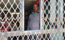 A foreign shop owner stands guard inside his Alexandra spaza shop on 26 January,2014. Picture: Vumani Mkhize/EWN.