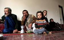 Jewish Rabbi Youssef Moussa, his nephew Haboub and his children Said and Jamil, and Nemaa, the Rabi's wife, sit in an apartment in Sanaa on 10 November, 2009 that was given to the family by the Yemeni government after fleeing from the conflict area in north Yemen. Picture: AFP