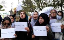 Women hold placards during a protest in Kabul on October 26, 2021, calling for the international community to speak out in support of Afghans living under Taliban rule.