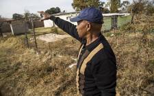 Willem Seboekoe gestures to a piece of land in Ennerdale, south of Johannesburg, which he claims belongs to his family that has been invaded by another family. Picture: Reinart Toerien/EWN