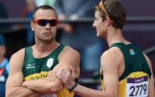 Oscar Pistorius and Willie de Beer before the 4x400m relay race. Picture: AFP
