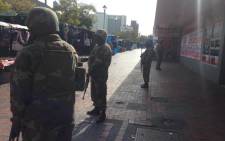 Police and army members have begun their raid as part of an anti-crime blitz in the Bellville CBD on 7 May 2015. Picture: Regan Thaw/EWN.