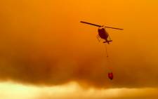 A screen grab from cellphone footage of a helicopter water bombing by VWS firefighter Dean Harrison.