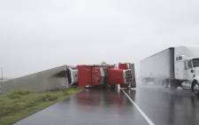 A big rig lies on its side on Hwy 59 near Edna, Texas, south of Houston, in the aftermath of Hurricane Harvey on 26 August, 2017. Picture: AFP.