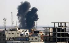 Smoke billows from a building struck during an Israeli air strike in Rafah in the southern Gaza Strip, on 7 August 2022. Picture: SAID KHATIB/AFP