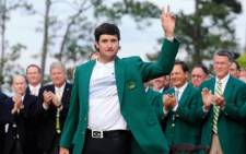 Bubba Watson poses with the green jacket after winning the 2014 Masters Tournament by a three-stroke margin at Augusta National Golf Club on 13 April 2014. Picture: AFP.