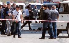 FILE:Investigators work at the site of a streetside bomb blast in Makhachkala, the capital of Russia's volatile Dagestan region, on 1 May, 2013. Picture:AFP