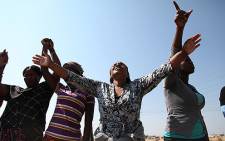 A congregation holds a prayer session at the scene of the Lonmin's Marikana shooting on 19 August 2012. Picture: EWN