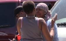 Hip-hop star Flabba's sister is comforted by relatives following the musicians murder at his Alexandra home, Monday 9 March 2015. Picture: Vumani Mkhize/EWN.