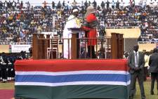Gambian President Adama Barrow (C) arrives on stage to take an oath during the inauguration ceremony for the start of his presidency at the Independence Stadium in Bakau, west of the capital Banjul, on February 18, 2017. Picture: AFP.