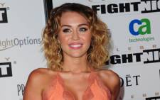Actress Miley Cyrus arrives at the Muhammad Ali's Celebrity Fight Night XVIII on March 24, 2012 in Phoenix, Arizona. The event supports the fight against Parkinson's disease and this year also celebrates Ali's 70th birthday. Picture: AFP.