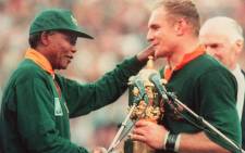 South African rugby team captain Francois Pienaar (right) is congratulated by South African President Nelson Mandela after South Africa won the Rugby World Cup final against New Zealand 24 June 1995 in Johannesburg. Picture: AFP.