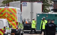 British police officers work near a lorry, found to be containing 39 dead bodies, as they work inside a police cordon at Waterglade Industrial Park in Grays, east of London, on 23 October 2019. Picture: AFP.