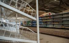 FILE: A picture shows empty shelves, including those for bread, in a grocery store in Harare on 9 October 2018, as Zimbabwe is experiencing renewed shortages. Picture: AFP